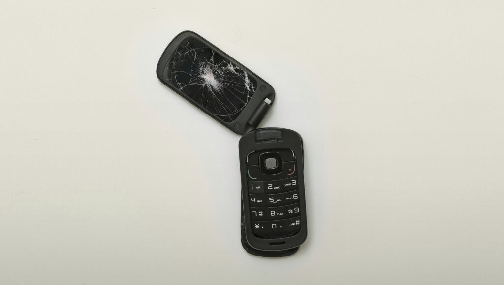 broken black flip phone \